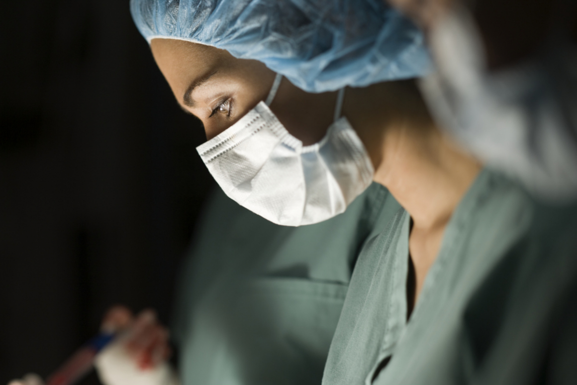 Profile of a female surgeon operating