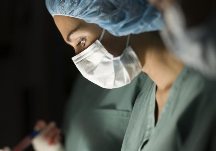 Profile of a female surgeon operating