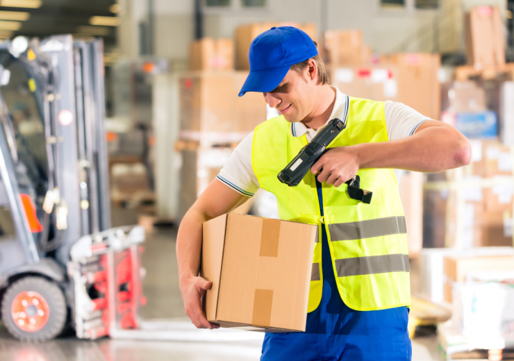 Logisitics - worker scans package in warehouse of forwarding